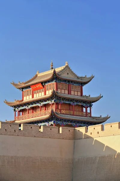 Three-story east gate tower over Guanghua Lou-Enlightenment Gate Jiayuguan fortress-rammed soil wall with red plaque reading Tian Xia Di Yi Xiong Guan-First and Greatest Pass under Heaven. Gansu-China