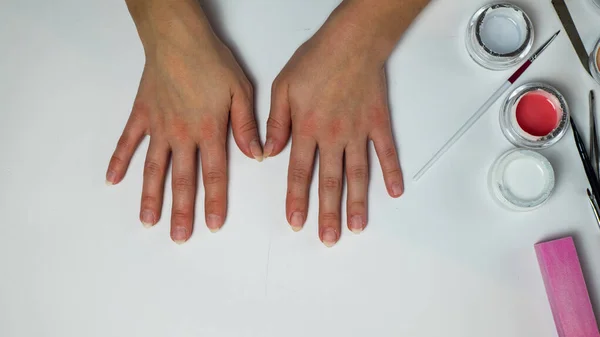 female hands on a white background. woman put her hands on the table