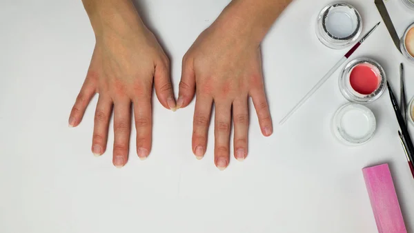 female hands on a white background. woman put her hands on the table