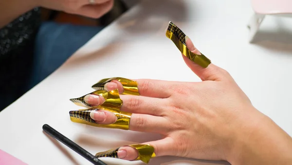 Manicure. Master make nail extension. hands closeup