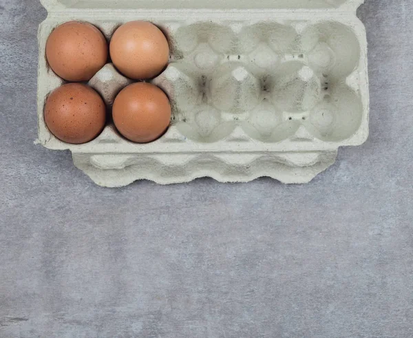 Plastic tray with eggs on a beton background, minimalism trend, top view