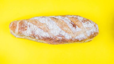 Italian bread on yellow background. Top view