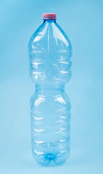 Plastic drink bottle isolated closeup on blue background