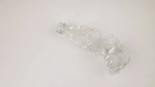 The plastic bottles used are crushed and crushed against a white background. Recycling concept — Stock fotografie