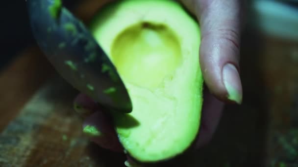 Opening fresh half-avocado. On the gray screen — Stock Video