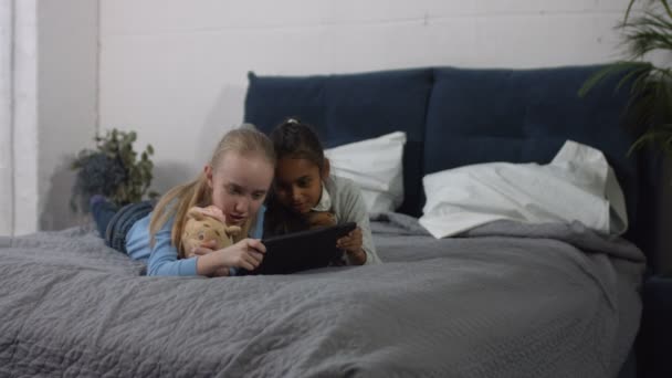 Diversity preteen girls playing tablet pc at home — Stock Video