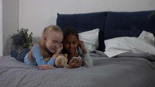 Diversity girls listening to music on smart phone — Stock Video