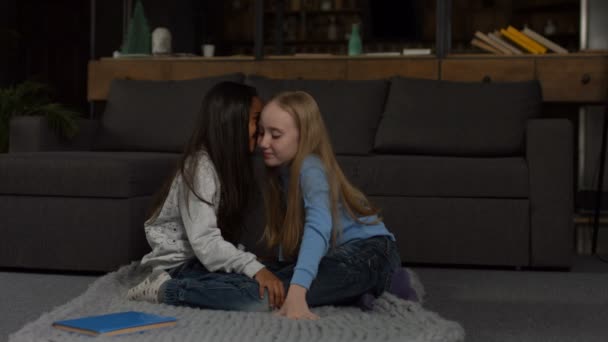 Two smiling grade school girls telling secrets — Stock Video