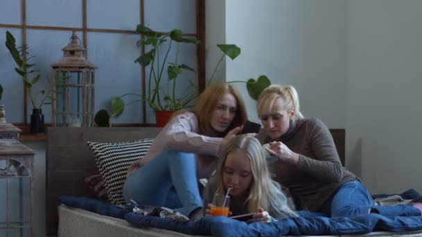 Zwei Freundinnen beobachten Medieninhalte am Telefon — Stockvideo