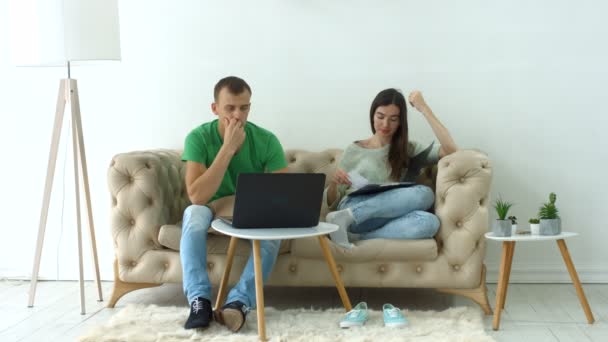 Worried couple doing their finances with laptop — Stock Video