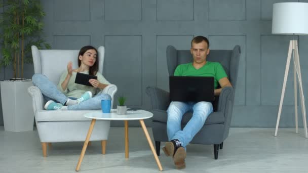 Casual casal de redes com dispositivos digitais em casa — Vídeo de Stock