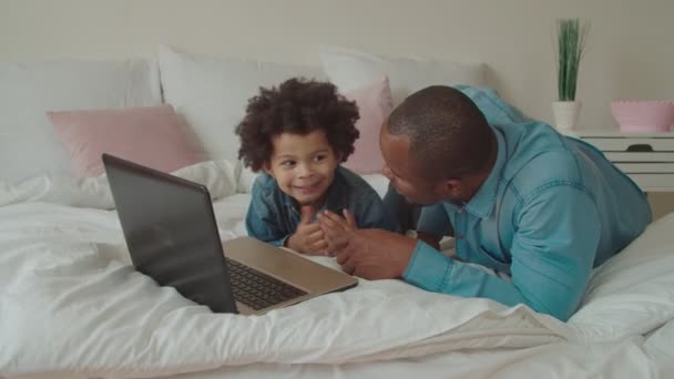 Black father and son streaming cartoons online — Stock Video