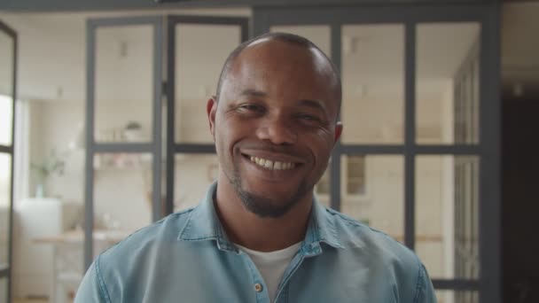 Φιλικός όμορφος μαύρος άντρας χαμογελάει μέσα. — Αρχείο Βίντεο