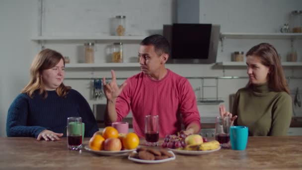 Hearing impaired couple teaching sign language to female — 비디오