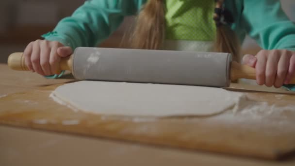 Детские руки выкатывают выпечку со скалкой — стоковое видео