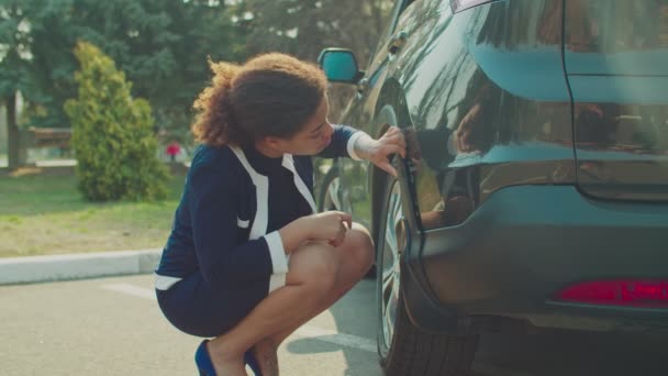 Hjälplös kvinna tittar på skadade repad bil — Stockvideo