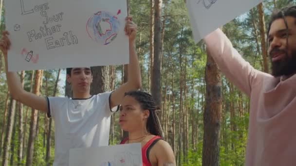 Group of diverse eco activists protesting outdoors — Stock Video