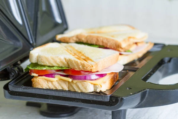 Sandwich toaster with toast and ingredients — Stock Photo, Image