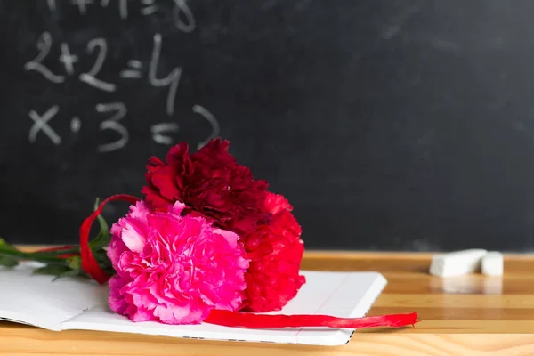 Flores y pizarra en el concepto de fondo del día del profesor de clase — Foto de Stock