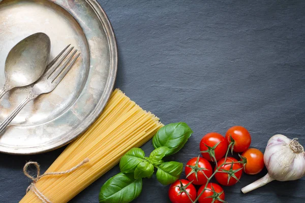 Makarna fesleğen domates sarımsak yemek arka plan kavramı üzerinde siyah mermer