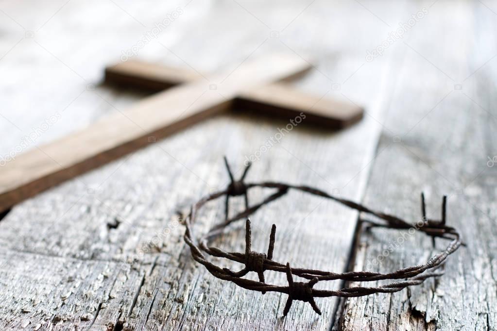 Easter abstract background with  crown of thorns and cross on wooden planks