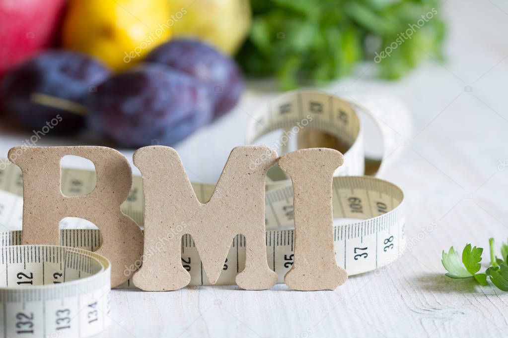 Body mass index BMI with measuring tape and fruits concept