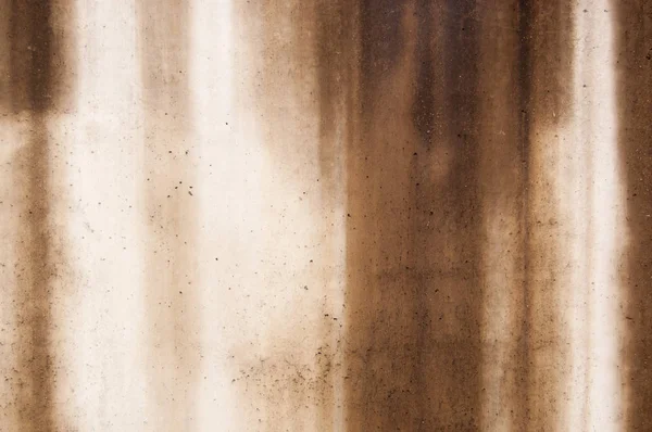 concrete wall covered with bad weather with vertical brown streaks