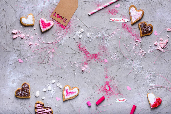 top view of heart shaped valentines cookies with love tag on grey surface with copy space