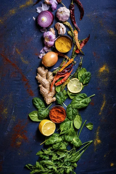 Top view of fresh, organic, healthy herbs, vegetables and spices on blue — Stock Photo