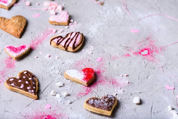 Close-up view of various delicious heart shaped valentines cookies on grey surface — Stock Photo