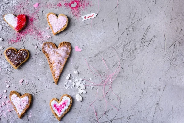 Vista superior de biscoitos em forma de coração doce para o dia dos namorados na superfície cinzenta rachada — Fotografia de Stock