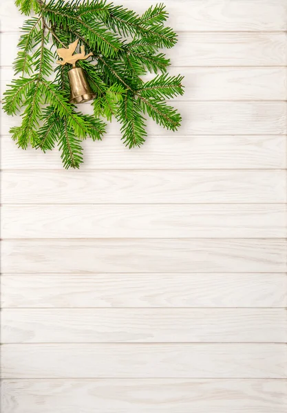 Christmas tree branches and bell — Stock Photo, Image