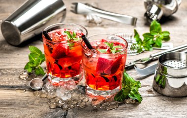 Red drink with strawberry, mint leaves, ice. Cocktail accessorie clipart