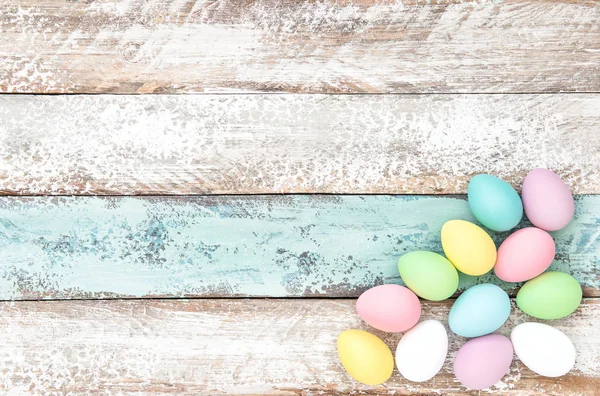 Pastel colored easter eggs wooden background — Stock Photo, Image