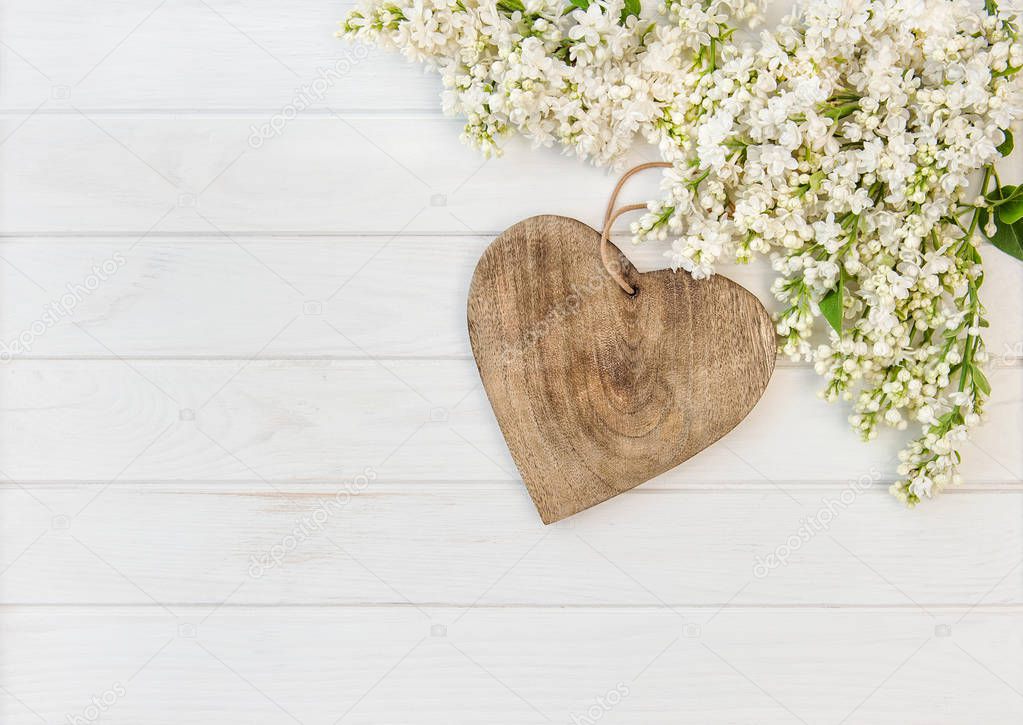 White lilac flowers wooden heart