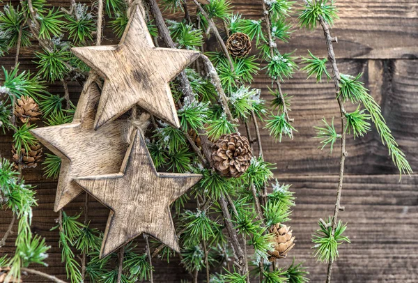 Christmas decoration wooden stars pine tree branches — Stock Photo, Image
