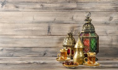 Doğu feneri, çay bardakları ve ahşap arka planda hurma ağaçları.
