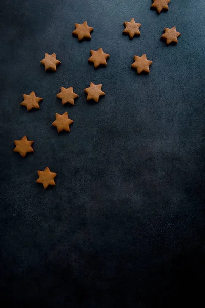 Christmas gingerbread star cookies on the dark blue background