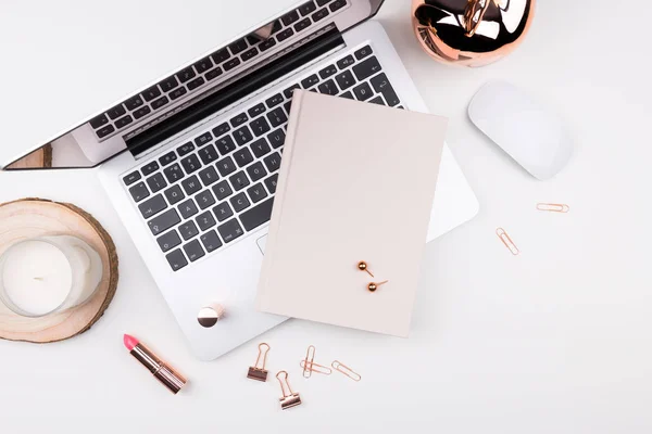 Feminine flat lay, top view workspace with laptop, candle, noteb — Stock Photo, Image