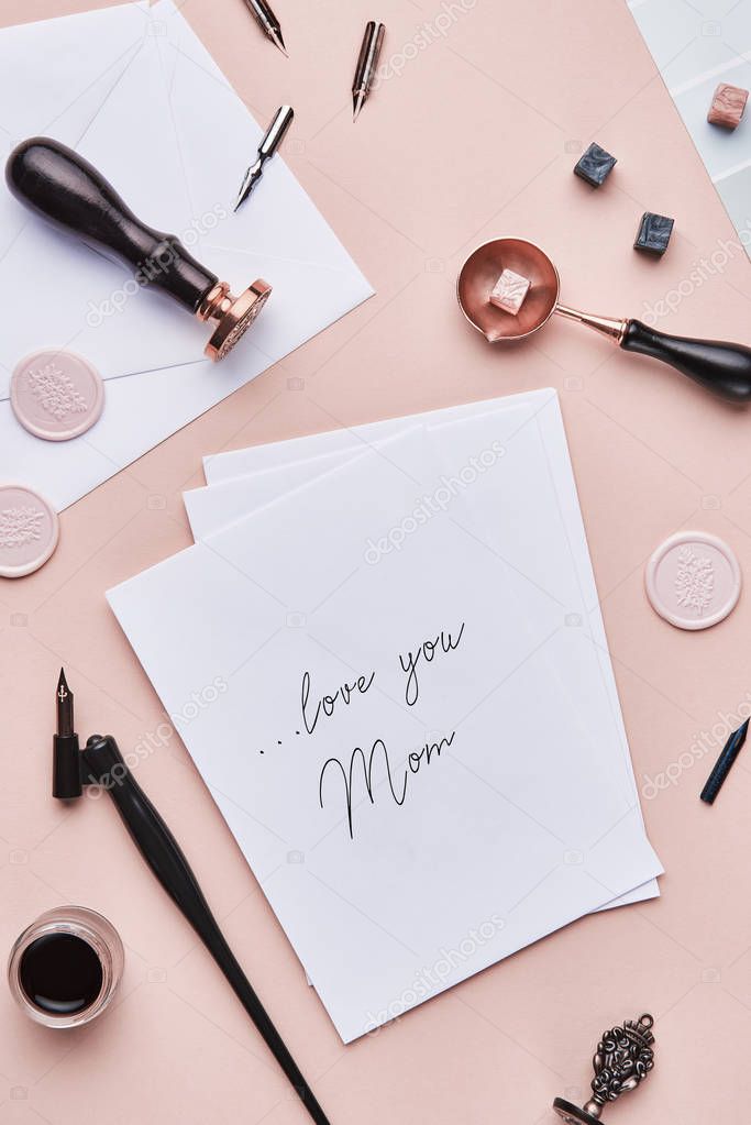Feminine desk workspace with quote: love you mom 