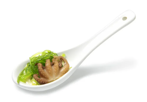 Octopus with hiyashi wakame salad on a ceramic spoon — Stock Photo, Image