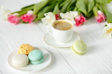 Kahve, pembe ve beyaz laleler ve macarons Beyaz ahşap tablo