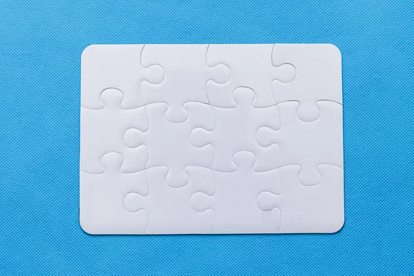 Jigsaw Puzzle with missing piece. Blue background.