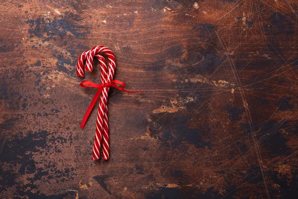 Candy canes on wooden background. Christmas composition