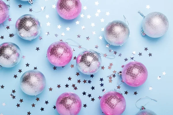 Composição de Natal Rosa, bolas de prata e brilhos no fundo azul pastel. Natal, inverno, conceito de ano novo — Fotografia de Stock