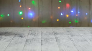 Hand push mini shopping cart with christmas tree and gifts on the background of led lamps garland. Concept of Christmas sale