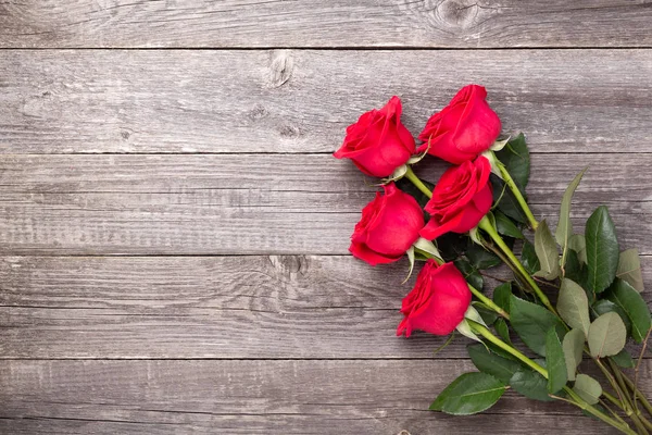 Red roses flowers on gray wooden table. Valentine's greeting card. Top view. Copy space Stock Image