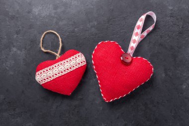 Sevgililer Günü tebrik kartı. Taş zeminde dekoratif tekstil kalpleri. Üst Manzara. Boşluğu kopyala