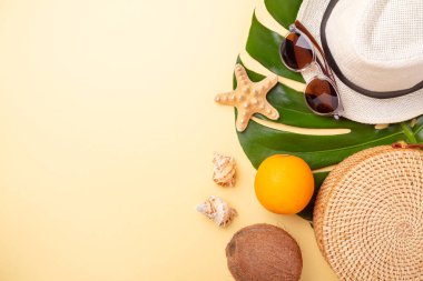 Yaz tatili afişi. Rattan çantası, güneş gözlüğü, şapka ve sarı arka planda egzotik meyveler. Seyahat konsepti. Düz yatıyordu. Uzayı kopyala - Resim
