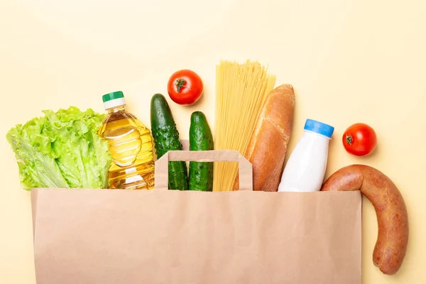 Grocery set in paper bag. Delivery service during quarantine, coronavirus covid-19. Top view - Image